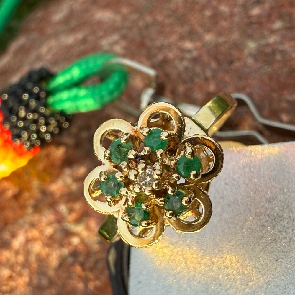 Vintage 14 Karat Gold with green emeralds and a diamond center stone.
